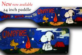 snoopy and woodstock toasting marshmallows at a campfire
