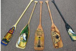 variety of designs painted on paddles